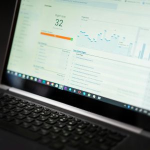 A laptop displaying an analytics dashboard with real-time data tracking and analysis tools.