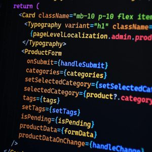 Close-up of JSX code on a monitor, showcasing colorful syntax used in ReactJS development.